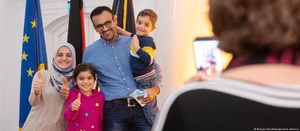 A happy Iraqi family of four who just got their German passports