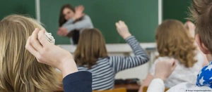 Students throwing objects at a teacher