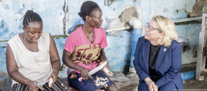 German Development Minister Svenja Schulze smiling at two African women